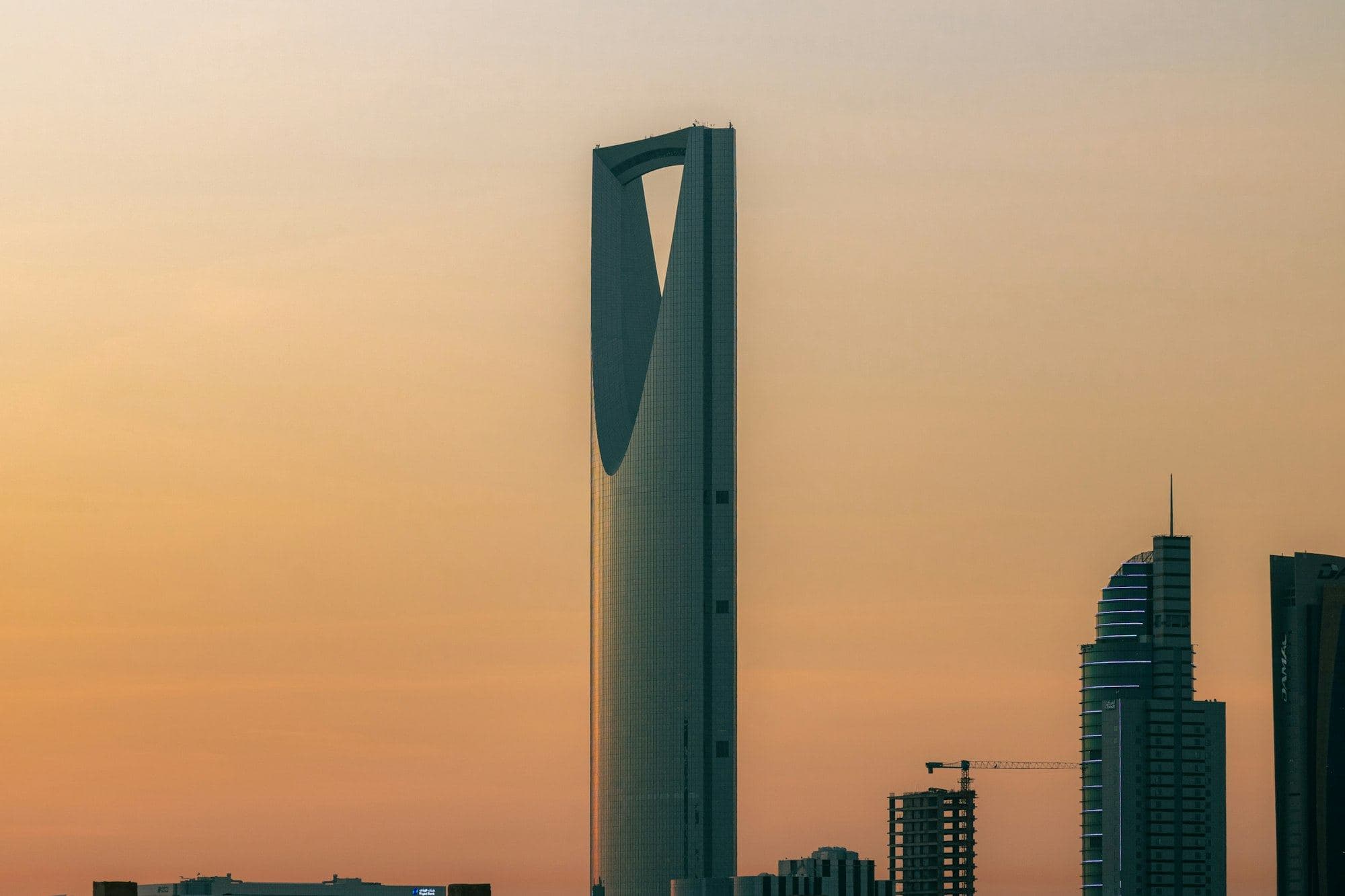 The Kingdom Centre tower in Riyadh against an apricot dusk sky