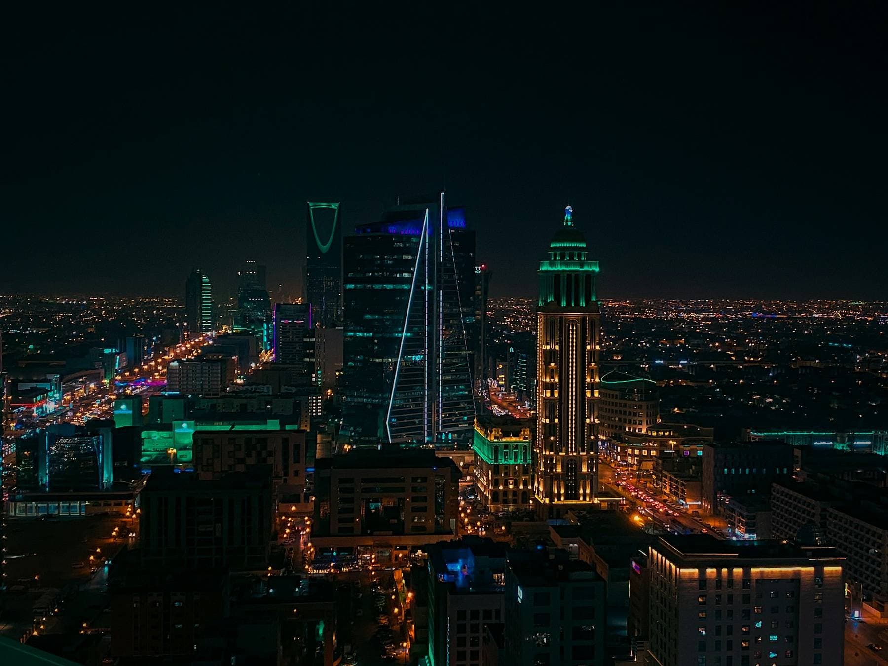 Riyadh at night with illuminated towers and glowing avenues