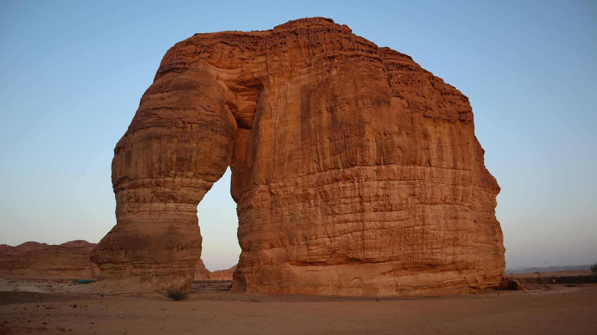 Elephant Rock, a sandstone arch in the AlUla desert at dusk